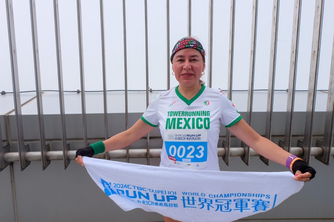 Minerva Hernandez of Mexico poses for photo on the 91st floor observation deck.