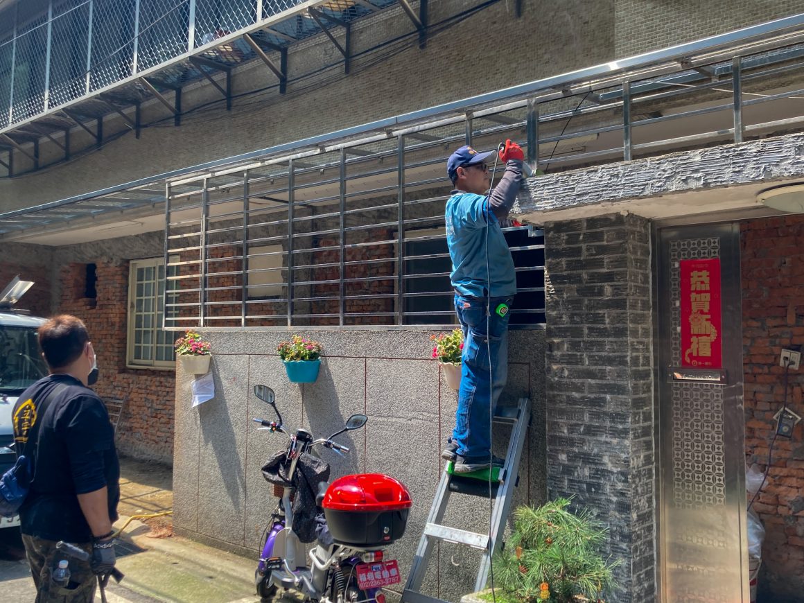  A worker installs a window cage.
